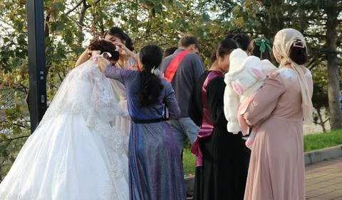 The bride's wedding preparations, surrounded by close guests Stock Photos