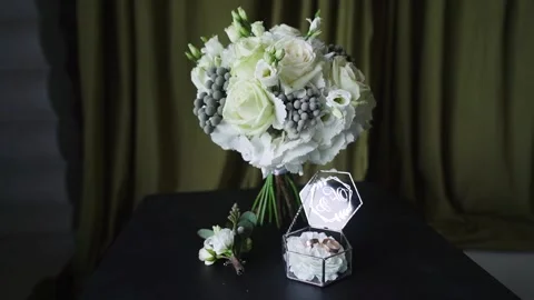 The bride's wedding rings and accessories lie side by side. Hit camera Stock Footage 256610950
