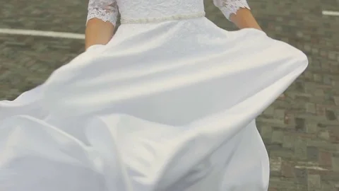 The bride's white dress develops in the wind. Stock Footage 75073539