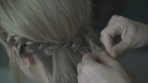 Bridesmaid braids the bride's braid while getting ready Stock Footage 171326879