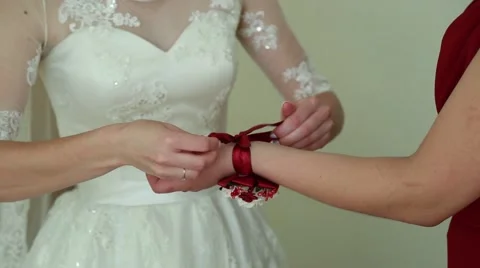 Bridesmaid is helping the bride to dress Stock Footage