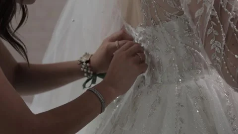 Bridesmaid Helping the Bride to Dress Up Stock Footage 300491753