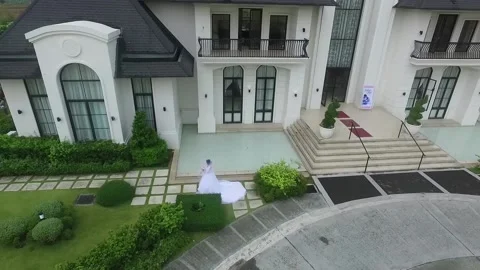 Bridesmaids walking down the aisle drone shot at clubhouse Stock Footage 161000472