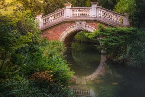 Bridge above pond with reflection in Parc Monceau, Paris, France Stock Photos