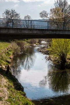 Bridge above the river and cloudy sky Stock Photos