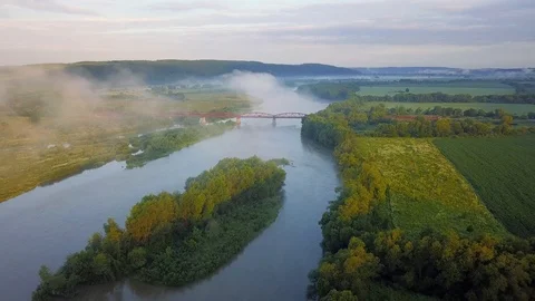 Bridge above river in the mist during sunrise Stock Footage 91927011