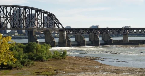 Bridge across Ohio River three friends walking in the distance wide Stock Footage 81914156