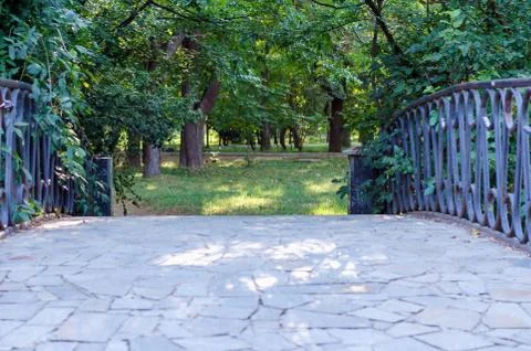 Bridge across a small river in a park Stock Photos