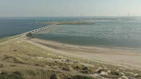 Bridge and flood barrier with wind engines on the coast of the Netherlands Stock Footage 325336582