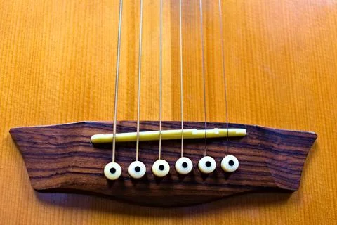 The Bridge and Pins of a Six String Guitar Stock Photos