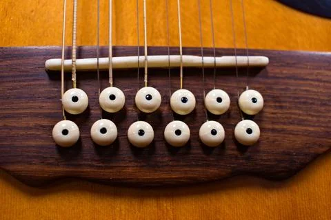 The Bridge and Pins of a Twelve String Guitar Stock Photos