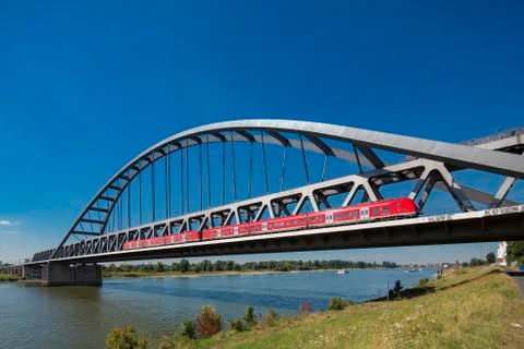 Bridge and red train over Rhein close to Dusseldorf Stock Photos