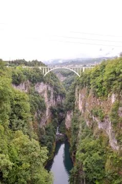 Bridge with an arch between two rock walls Stock Photos