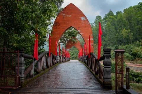 Bridge with archs and red flags in the entrance to My Son Stock Photos