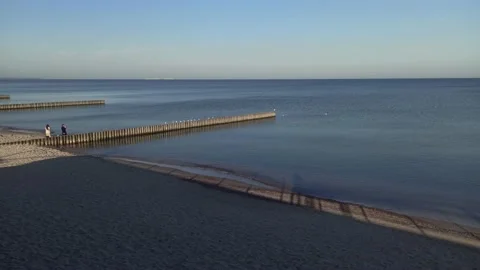 A bridge on the beach by the sea on which the waves come Stock Footage 163342055