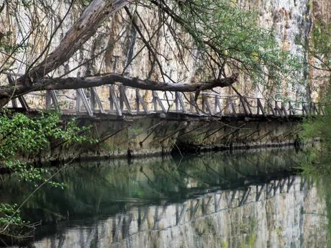 Bridge between the river and the rock massif Stock Photos