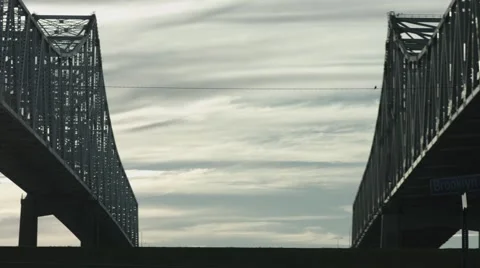 Bridge as Biker passes Left To Right on Levy Stock Footage 68383254