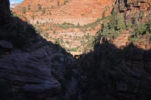 The bridge at the bottom of the red rock cliffs with shades in Zion National  Stock Photos