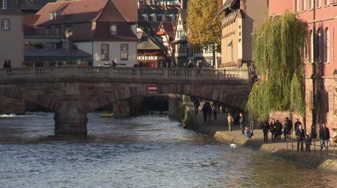 Bridge in center of Strasbourg with people strolling on channel embankment Stock Footage 59185811