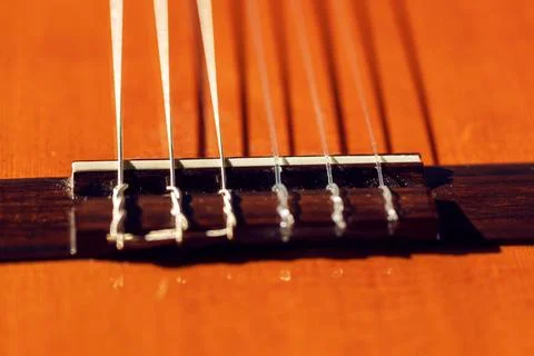 Bridge of classical guitar with nylon strings Stock Photos