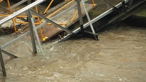 The bridge collapsed into the river and began to flood. The flood destroyed the Stock Footage 278612439