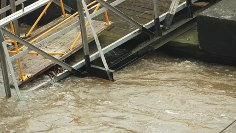 The bridge collapsed into the river and began to flood. The flood destroyed the Stock Footage 278612490