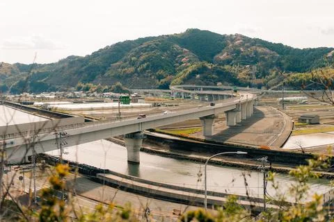 A bridge complex passing over a body of water and intersecting with other roads Stock Photos