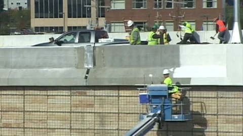 Bridge Construction -guys paint top edge Stock Footage 105553230