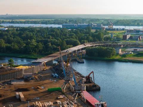 Bridge Construction Site Over River in Riga, Latvia at Sunrise or Sunset 库存照片