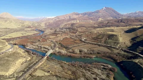 A bridge crosses a river in a mountain landscape Stock Footage 327961850