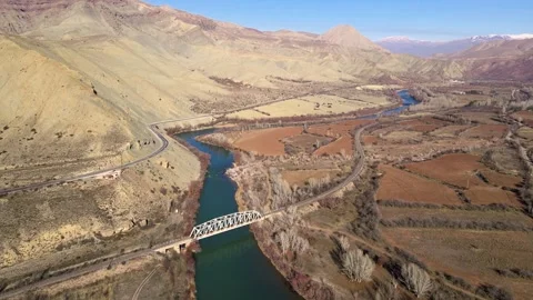 A bridge crosses a river in a mountain landscape Stock Footage 327963336