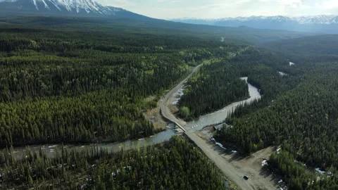 Bridge crossing over a river through the valley, drone shot Stock Footage 289575454