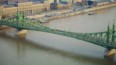 Bridge crossing the river in Budapest with calm water and surrounding city Stock Footage 326065694