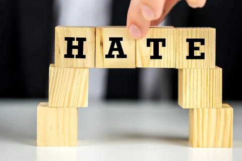 Bridge of cubes with word hate written on them Stock Photos