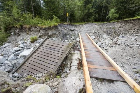 A bridge destroyed by flash flooding below La Fouly in the Swiss Alps. Stock Photos