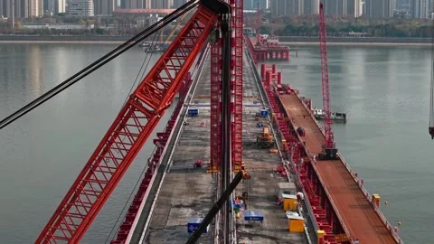 Bridge dismantling progress over river with large cranes and heavy equipment Stock Footage 325717743