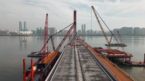 Bridge dismantling progress over river with large cranes and heavy equipment Stock-Footage 335643534
