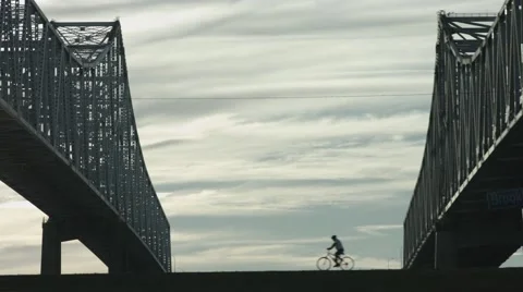 Bridge with Fast Biker Right To Left, Silhouetted Stock Footage 68397337