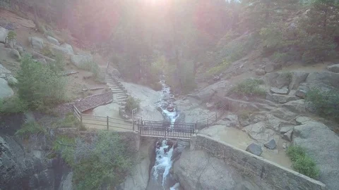 Bridge flyover to woods and stream Stock Footage 84956673