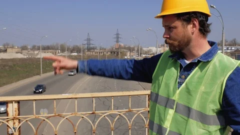On the bridge is a foreman with a beard and mustache in a yellow helmet. 4k Stock Footage 106356339