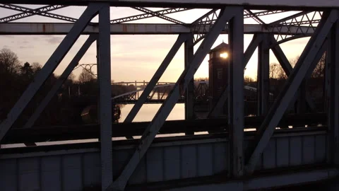 Bridge framework track. Multiple bridges backlit. Tracking shot. 4K Stock Footage 150572931