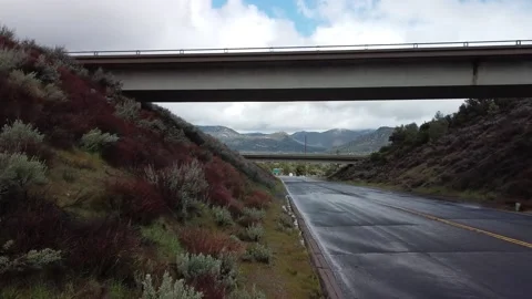 BRIDGE - FREEWAY - MOUNTAINS - MOVING CLOUDS - EPIC LIGHT Stock Footage