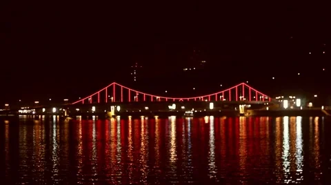 The Bridge Goes Into Twinkling Lights, it is Red at Night Multicolored Lights Stockbeeldmateriaal 67402030