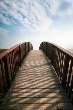 Bridge going up toward sky. Walkway on Sylt island, at North sea Stock Photos
