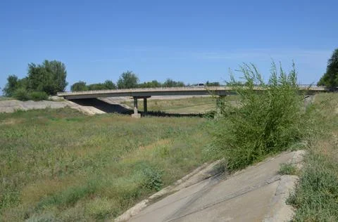 A bridge has been built over a water channel in which there is no water. Stock Photos