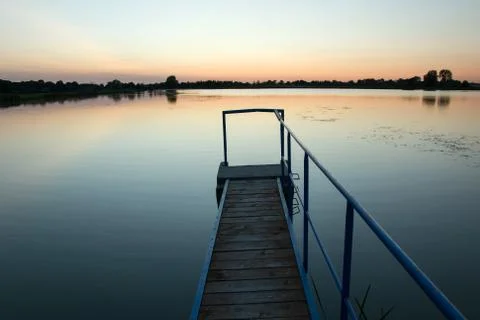 Bridge on the lake and cloudless sky after sunset. Staw, Poland Stock Photos