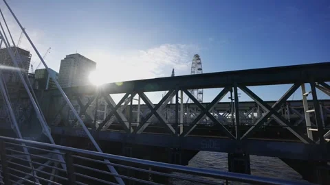 A bridge with a large Ferris wheel in the background Stock Footage 297860110