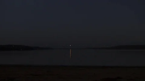 Bridge Lights Over River at Night Stock Footage 77075811