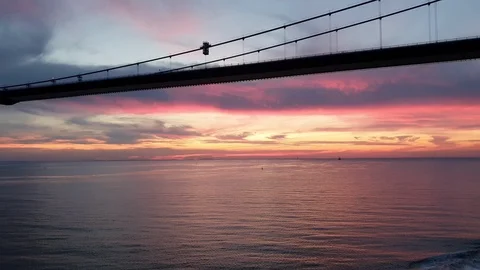 Bridge with long powerful ropes under cloudy sunset sky Stock Footage 113189286