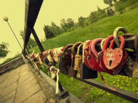Bridge of love with multi-colored padlocks of the newlyweds. Padlocks with ke Stock Photos